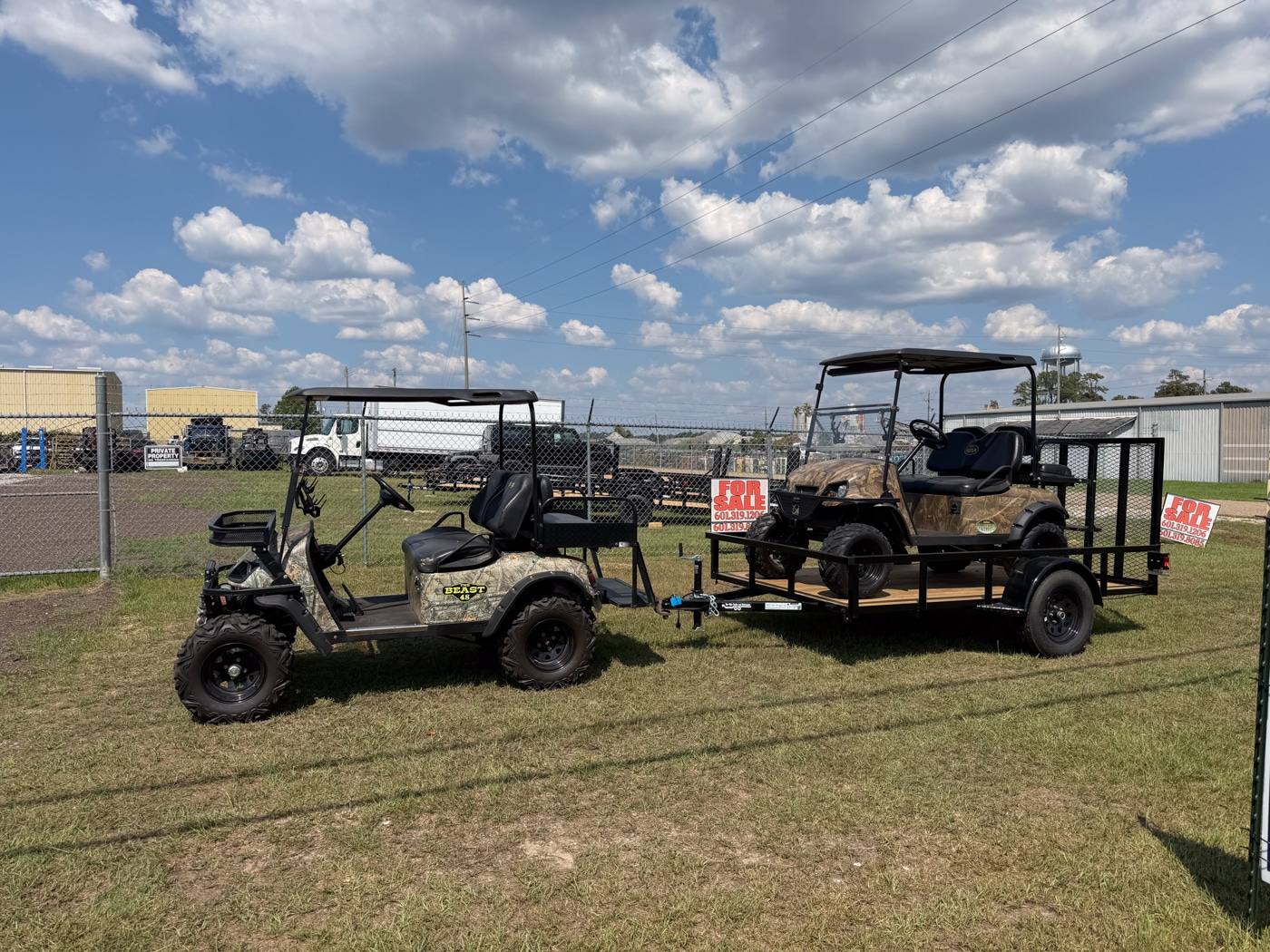 Camouflage golf cart pulling another cart on a Bye-Rite trailer at Southern Cart Co.