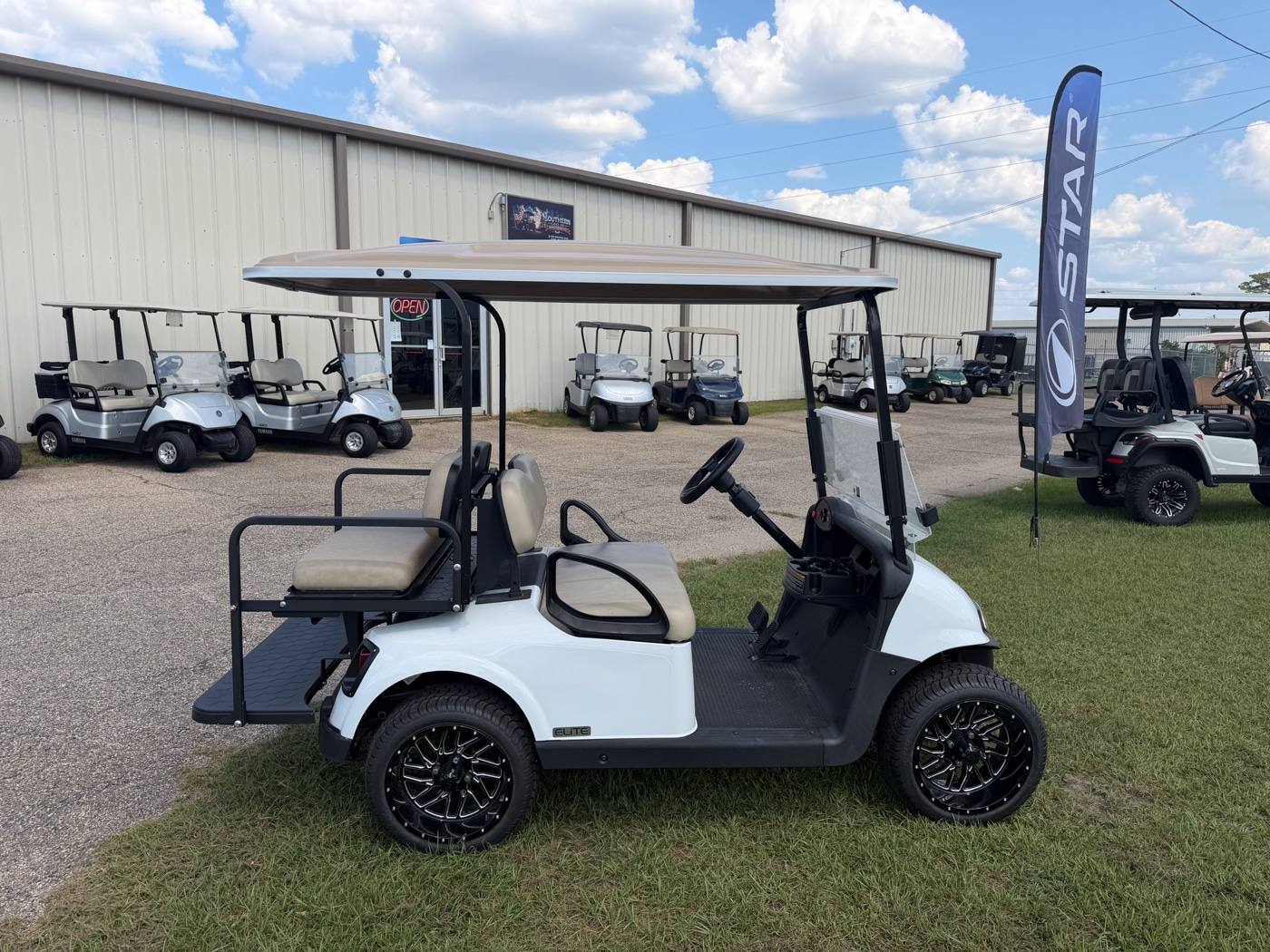Street legal white golf cart with headlights and mirrors outside Southern Cart Co.